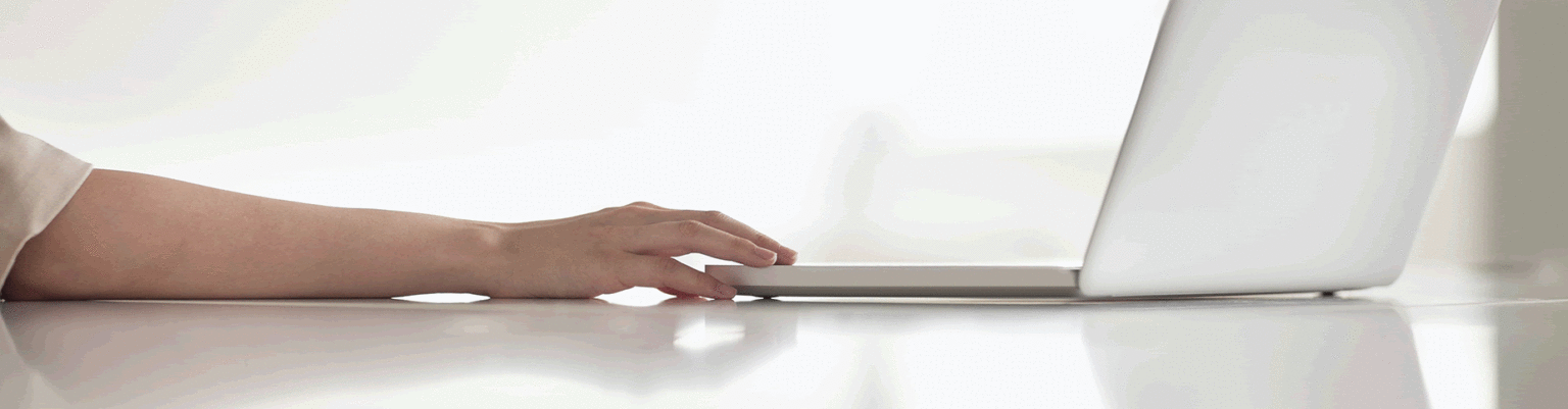 Persons hand reaching out to laptop keyboard